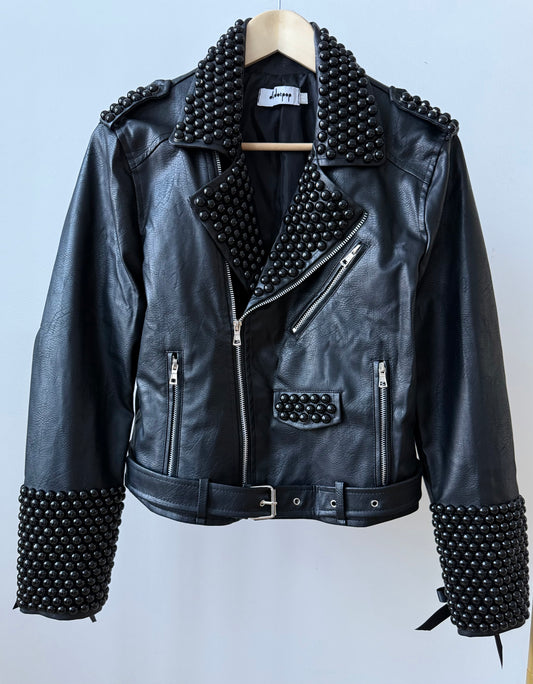 Black faux PU leather moto biker jacket showcasing dome studs and satin lace-up sleeves.