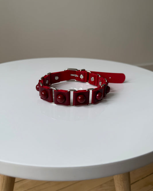 DOTDOTPOP red dome studded choker necklace with PU faux leather. Edgy and trendy design for streetwear and statement fashion.